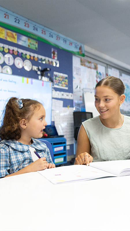 Sacred Heart Mt Druitt teacher assisting students in class