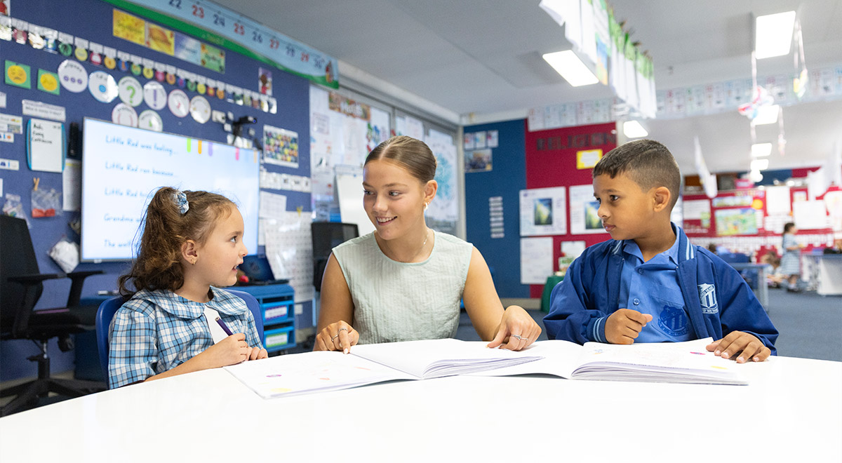 Sacred Heart Mt Druitt teacher assisting students in class