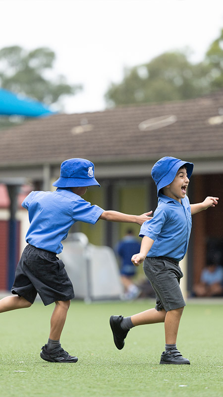 Sacred Heart Mt Druitt students playing on sports field