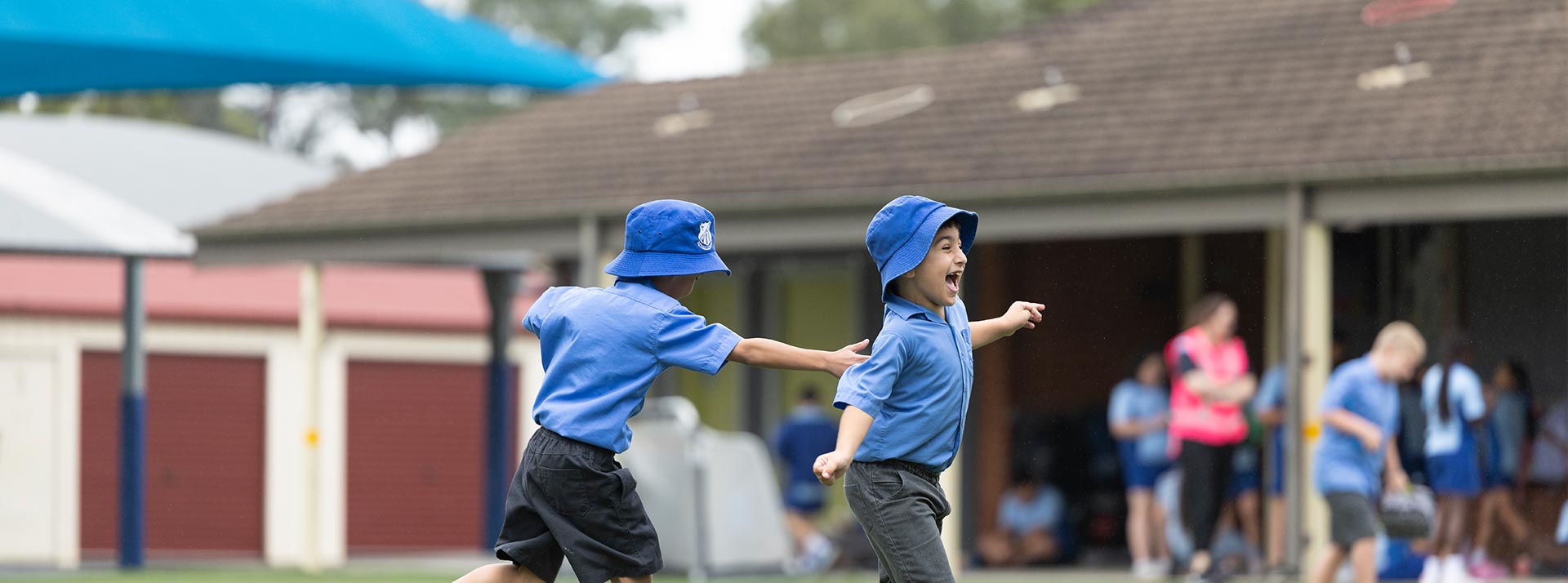 Sacred Heart Mt Druitt students playing on sports field