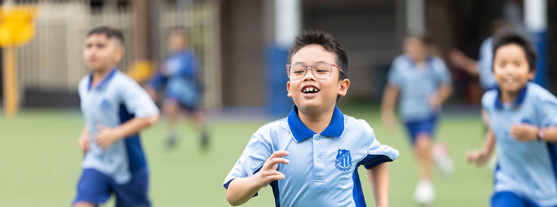 Sacred Heart Mt Druitt students playing on sports field