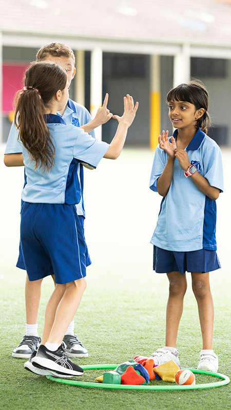 Sacred Heart Mt Druitt students playing on sports field