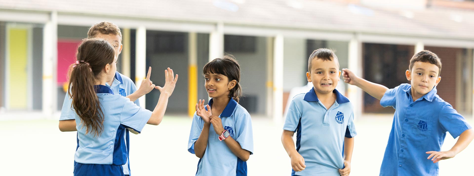 Sacred Heart Mt Druitt students playing on sports field