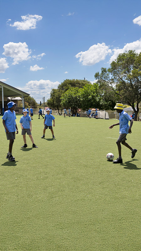 Sacred Heart Mt Druitt students playing soccer on outdoor sports field