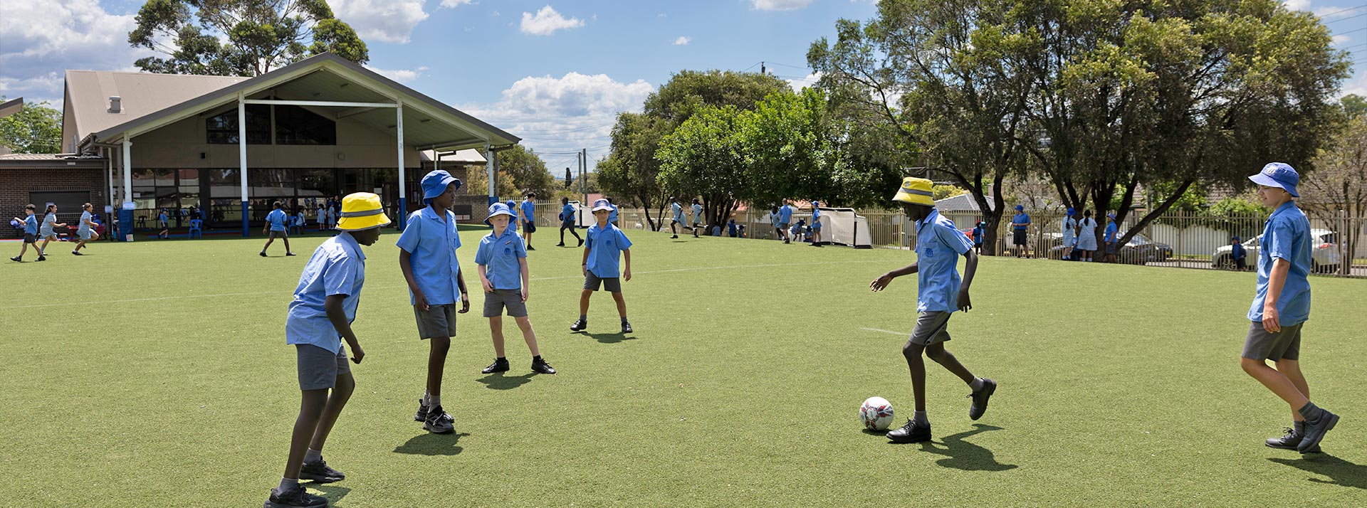 Sacred Heart Mt Druitt students playing soccer on outdoor sports field
