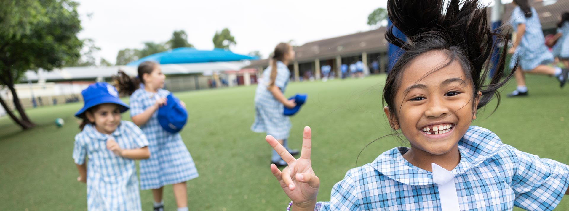 Sacred Heart Mt Druitt students playing on sports field