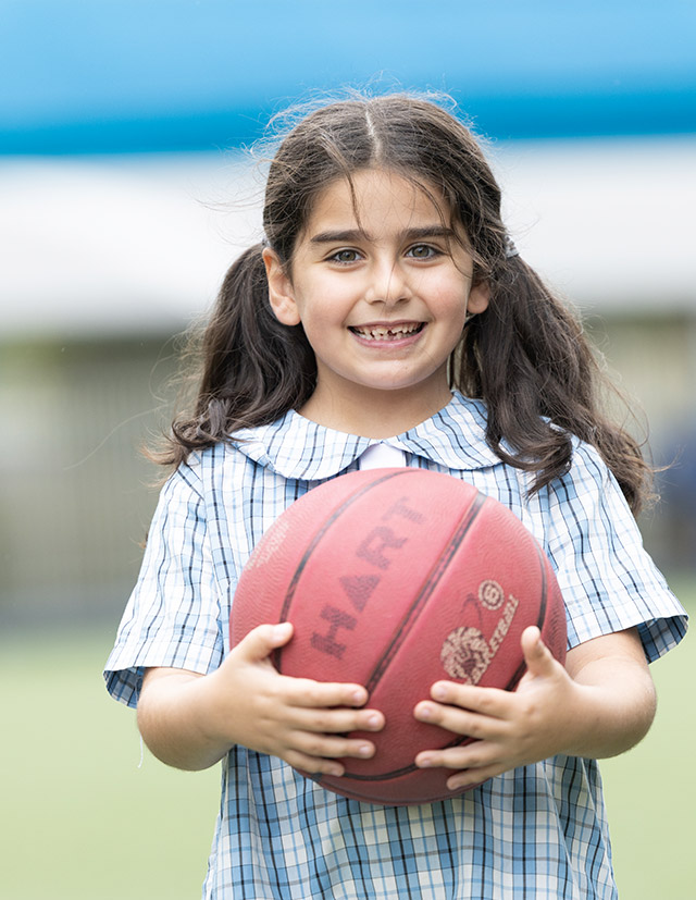 Sacred Heart Mt Druitt student holding a basket ball
