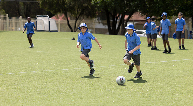 Sacred Heart Primary students playing soccer on outdoor field