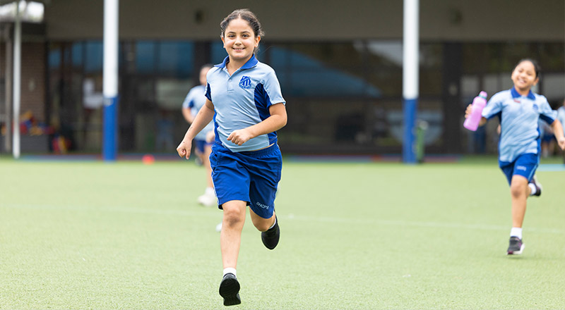 Sacred Heart Mt Druitt students playing on sports field