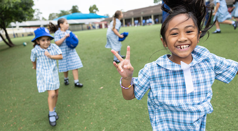 Sacred Heart Mt Druitt students playing on sports field