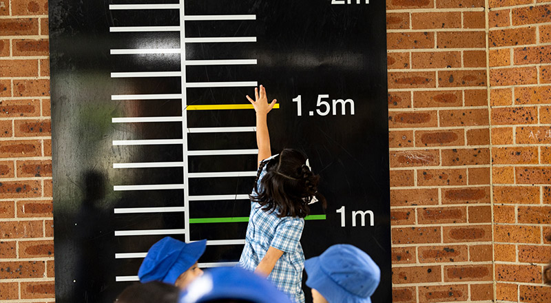 Sacred Heart Mt Druitt Primary student measuring her height