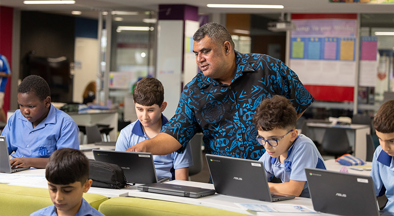 Sacred Heart Mt Druitt teacher assisting students in class