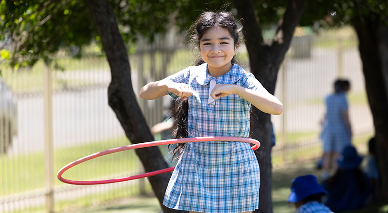 Sacred Heart Mt Druitt students playing on sports field
