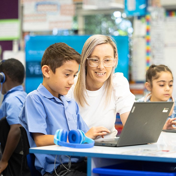Sacred Heart Mt Druitt teacher assisting students in class