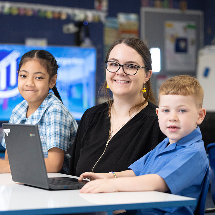 Sacred Heart Mt Druitt teacher assisting students in class