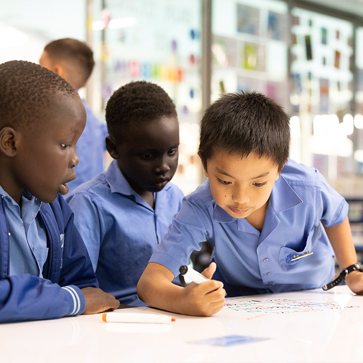 Sacred Heart Mt Druitt students in class writing on whiteboard