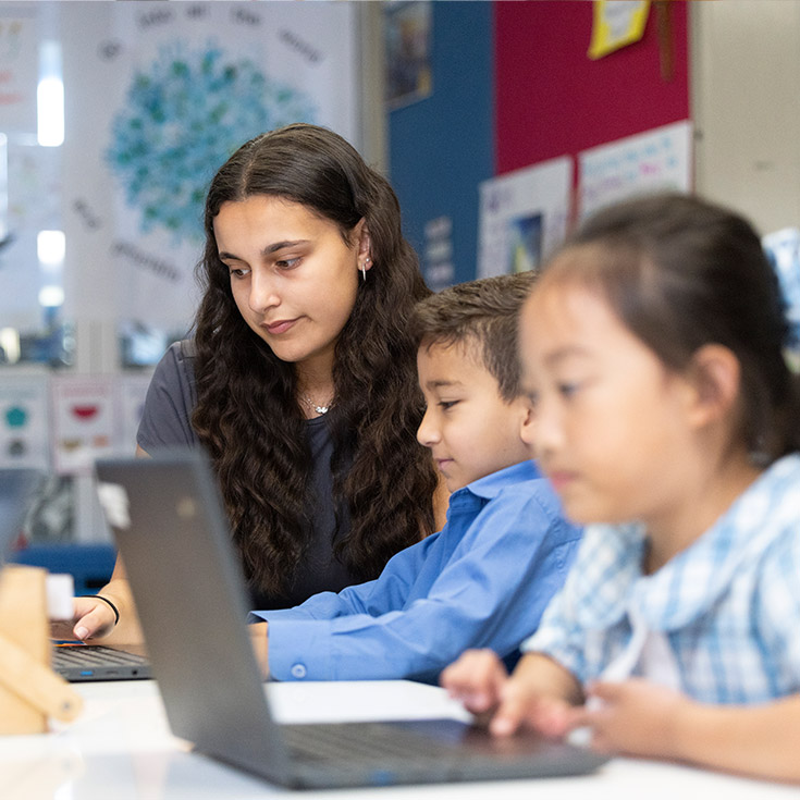Sacred Heart Mt Druitt teacher assisting students in class