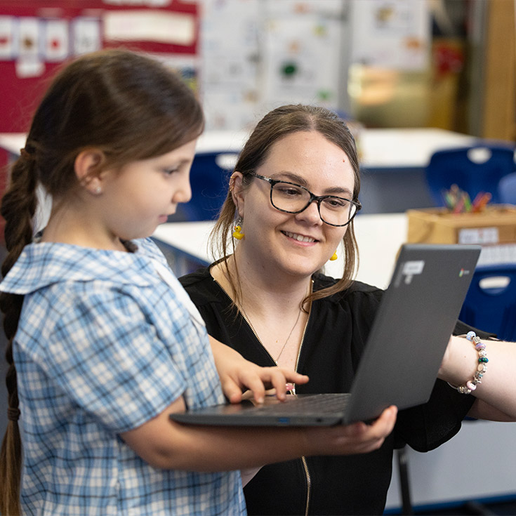 Sacred Heart Mt Druitt teacher assisting students in class