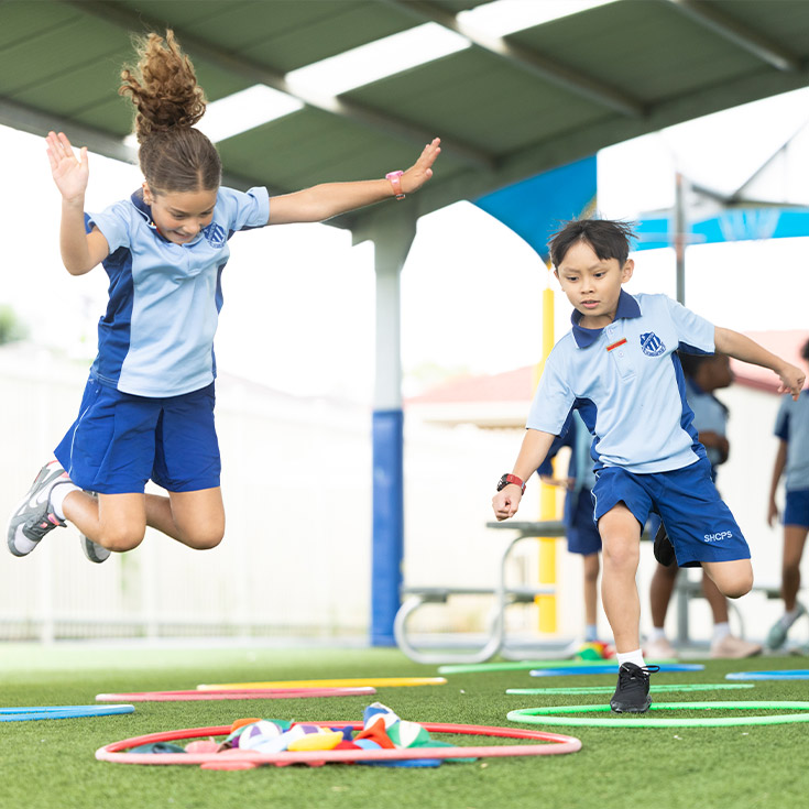 Sacred Heart Mt Druitt students playing under covered outdoor area